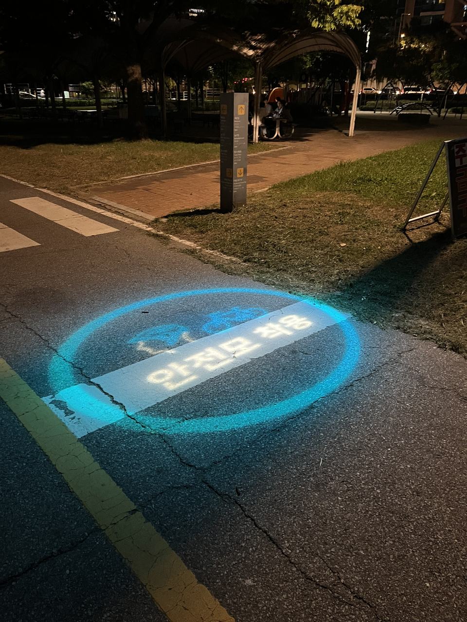 Bike lane at night with guiding lights projected onto the path